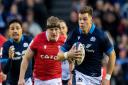 Huw Jones breaks clear against Wales in the 2023 Six Nations