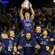 Scotland doctor James Robson lifts the Calcutta Cup on the shoulders of Pierre Schoeman as he bids farewell to Murrayfield after more than 30 years as Scotland team doctor